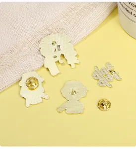 Detailed macro view of the gold metal brooch back with textured finish and butterfly clutches