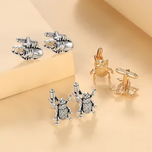 Detail of vintage beetle and fly cufflinks in gold and silver finish for men