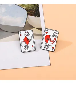 Close-up of enamel poker card pins featuring creative cat motifs in red and black