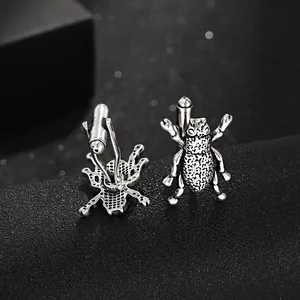 Detail of silver beetle cufflinks with vintage texture and secure bullet back closures