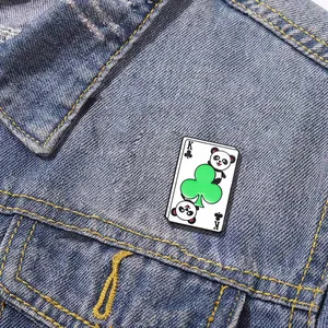 Cartoon panda king of clubs playing card enamel pin badge on blue denim jacket