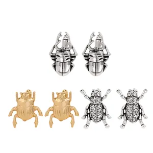 Three pairs of beetle-shaped shirt cufflinks in silver and gold metal finishes