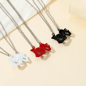 Detailed macro view of zinc alloy couple necklaces with LOVE lettering and heart engraving