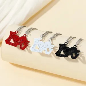 Close-up of three zinc alloy LOVE heart-shaped necklaces in red, white and black colors