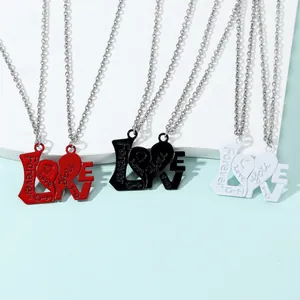 Detail showing red black and white LOVE puzzle heart necklaces with Forever engravings