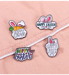 Detail of four colorful Easter enamel pins featuring bunny ears and holiday greetings