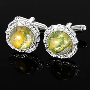 Macro shot of silver cufflinks with marble texture and rhinestone circular border