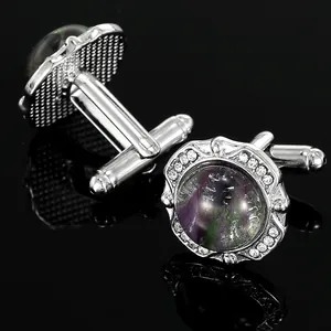 Detailed view of silver cufflinks featuring round dragon breath glass and white rhinestones
