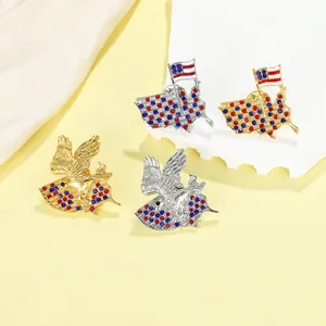 Detail of vintage American eagle and map brooches with crystals and colorful enamel