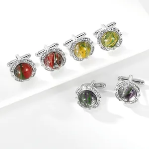 Detailed macro shot of round silver cufflinks with crystal inlay and nebula glass patterns