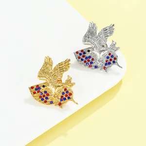 Macro detail of eagle brooches with colorful rhinestones in gold and silver finishes