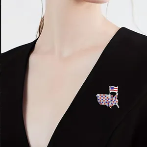 Detail of USA map brooch with red white and blue crystals on black clothing