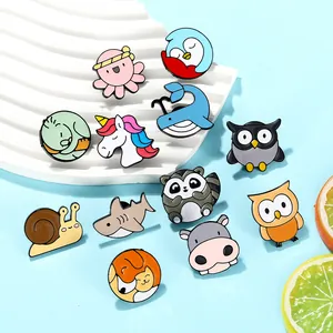 Macro view of 12-piece cartoon animal enamel pin set including owl snail and whale shapes