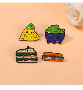 Macro shot of cute cartoon enamel food pins featuring sandwich and taco characters