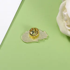Back view of golden enamel cat brooch with metal mesh texture and butterfly clutch pin