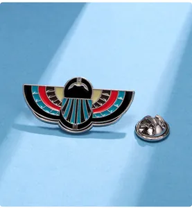 Detail showing vintage Egyptian winged beetle enamel brooch with secure metal pin backing