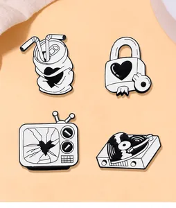 Detailed view of four minimalist black and white enamel pins with heart-themed vintage designs