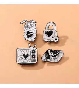 Detailed close-up of retro black and white enamel pins with heart-themed metal designs