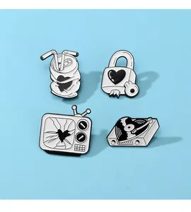 Set of 4 black and white enamel pins featuring vintage record player and heart padlock design