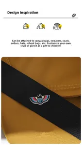 Detail of colorful enamel wings brooch featuring ancient Egyptian design on black fabric
