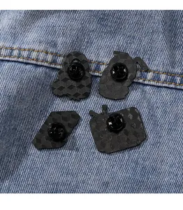 Detail view of four retro metal badges with honeycomb texture on blue denim fabric