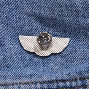 Silver wing-shaped metal badge featuring a butterfly clutch and anti-slip grid texture