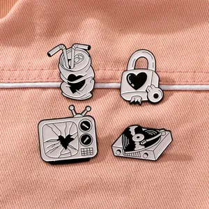 Set of four black and white retro enamel pins featuring heart-themed vintage designs