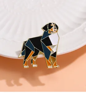 Detailed view of a geometric enamel Bernese Mountain Dog brooch on a white plate
