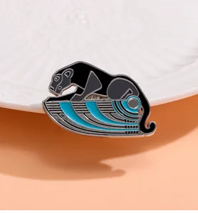 Detailed view of an Egyptian leopard enamel brooch with black finish and blue base