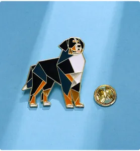 Detail of a Bernese Mountain Dog enamel pin with geometric design and golden clutch back