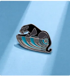 Detail of artistic black leopard enamel brooch with teal Art Deco style base