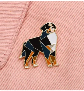 Detailed macro view of geometric Bernese Mountain Dog enamel pin on pink denim fabric