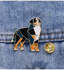 Detail of geometric Bernese Mountain Dog enamel pin on blue denim fabric background