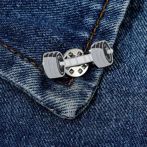 Detail of barbell enamel pin on blue denim jacket collar with zinc alloy finish