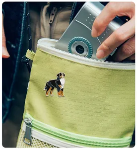 Artistic Bernese Mountain Dog enamel pin attached to a light green canvas tote bag