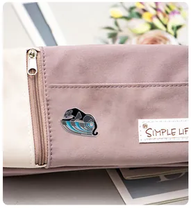 Detail of an Egyptian leopard enamel pin pinned on a canvas bag with Simple Life label