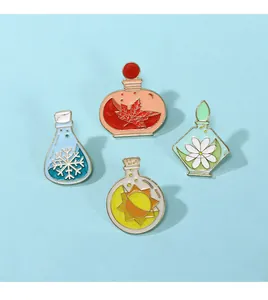 Macro view of four enamel pins with seasons and nature elements in fantasy bottles