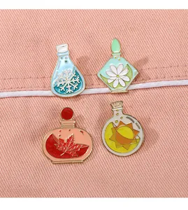 Detailed view of four seasonal enamel pins featuring snowflake, daisy, maple leaf and sun icons