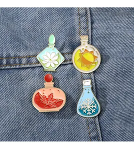 Detail of four seasonal enamel pins featuring spring flowers and winter snowflakes on denim