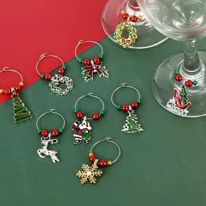 Detailed view of Christmas wine glass charms with festive beads and metal charms on glassware