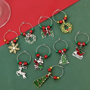 Detailed view of 9 Christmas wine glass charms with enamel snowman and reindeer motifs