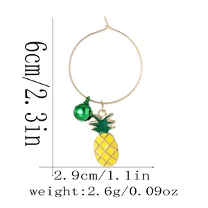 Detail view of pineapple pendant earrings with size measurements in centimeters and inches