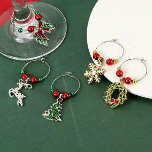 Detailed view of Christmas wine glass charms with festive beads and enamel pendants