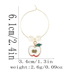 Detail of apple enamel hoop earring with pearls and dimensions 6.1cm by 3.4cm