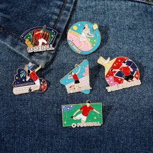Close-up of colorful sports enamel pins on denim, showing baseball and football designs