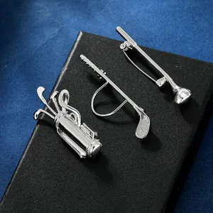 Detail of silver golf theme jewelry set featuring club-shaped ring and brooch on black box