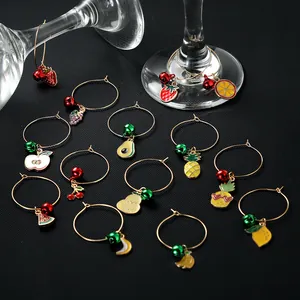 Detailed view of 12 colorful fruit wine glass charms with gold metal rings and small bells