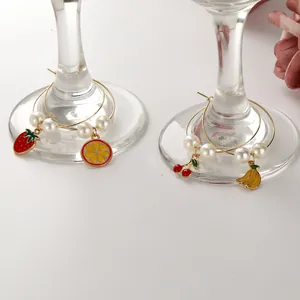 Set of four fruit wine glass charms with strawberry, orange, cherry and banana pendants