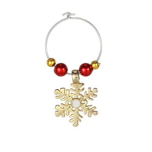 Christmas napkin ring with red beads and golden snowflake pendant on a silver metal hoop