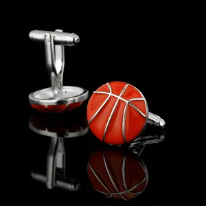 Detailed macro view of orange basketball cufflinks with silver metal lines on black background